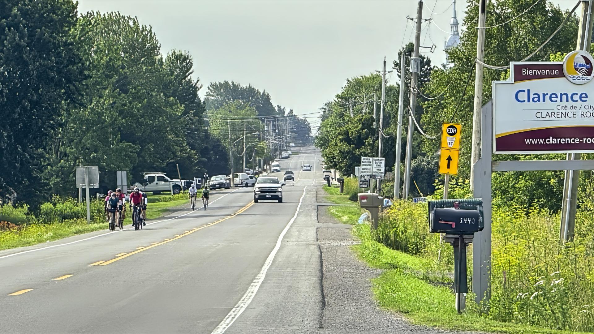 street view of Landry street with bikers and City Signage announcing Welcome to Clarence-Rockland