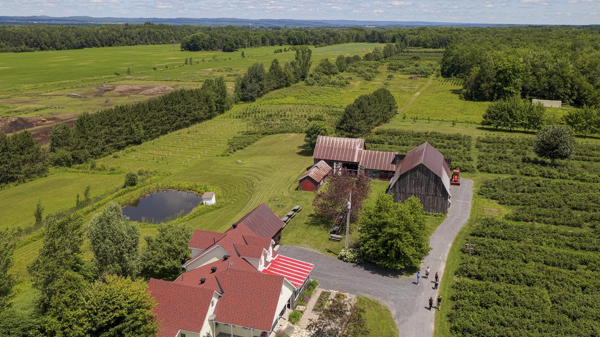 Drone view of Verger Villeneuve farm showing barns and fields